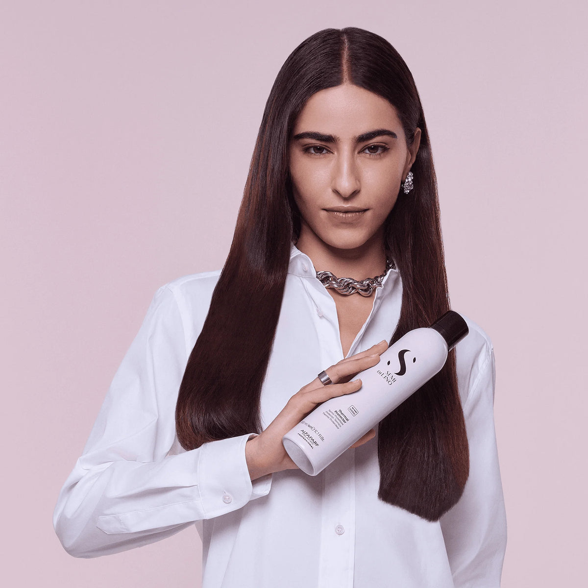 Modelo de cabello largo y liso sosteniendo Alfaparf Semi di Lino Thermal Protector 300 ml, protector térmico sin fijación.